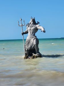 statue of poseidon in tropical ocean waters